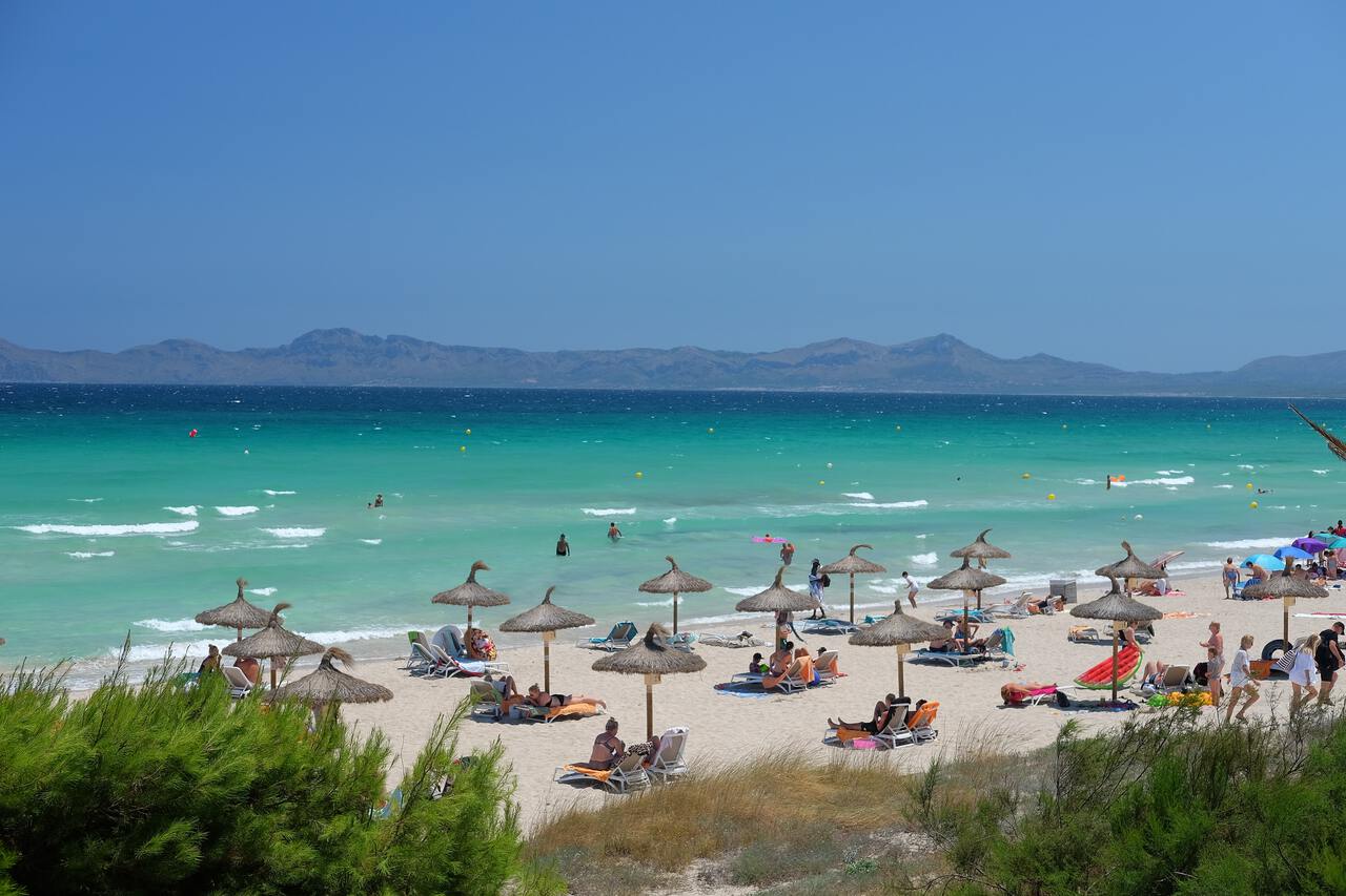 Visitors arriving at the Magaluf beach for an afternoon swim